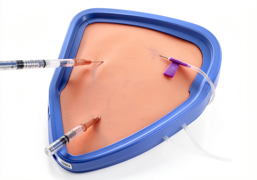 Installing Omana Injection Training Pad Soft Silicone Model with Dual Syringes on a wooden desk